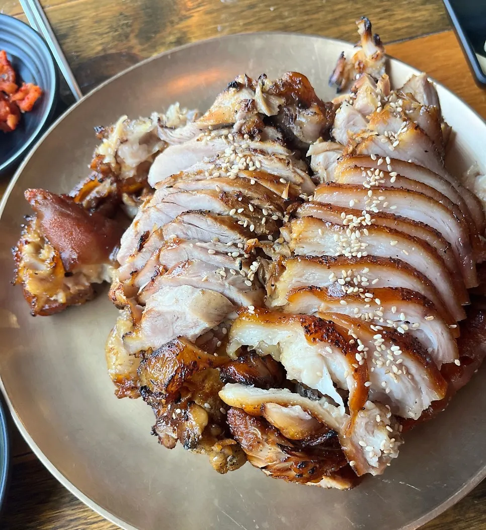 Picking up a piece of jokbal with chopsticks