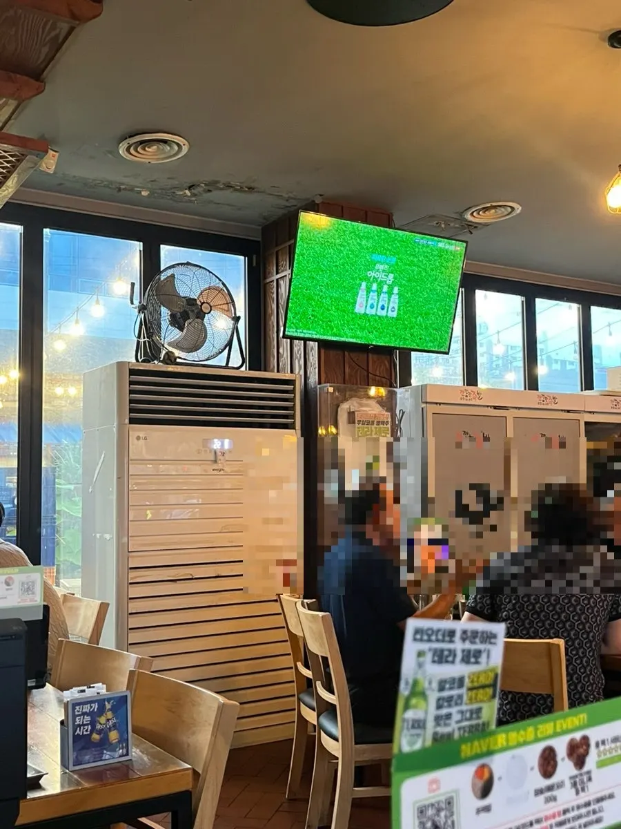 Wall-mounted TV and projector screen inside the restaurant