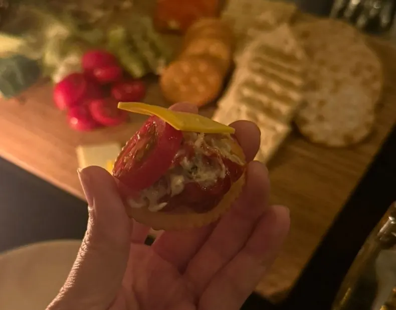 Tuna and toppings piled on a cracker