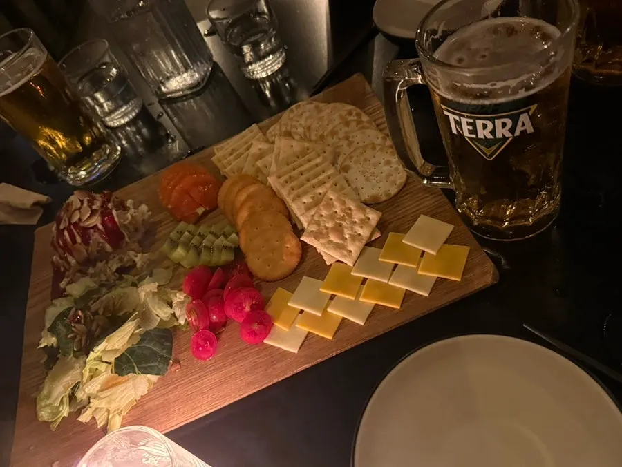 Tuna cracker platter next to beer