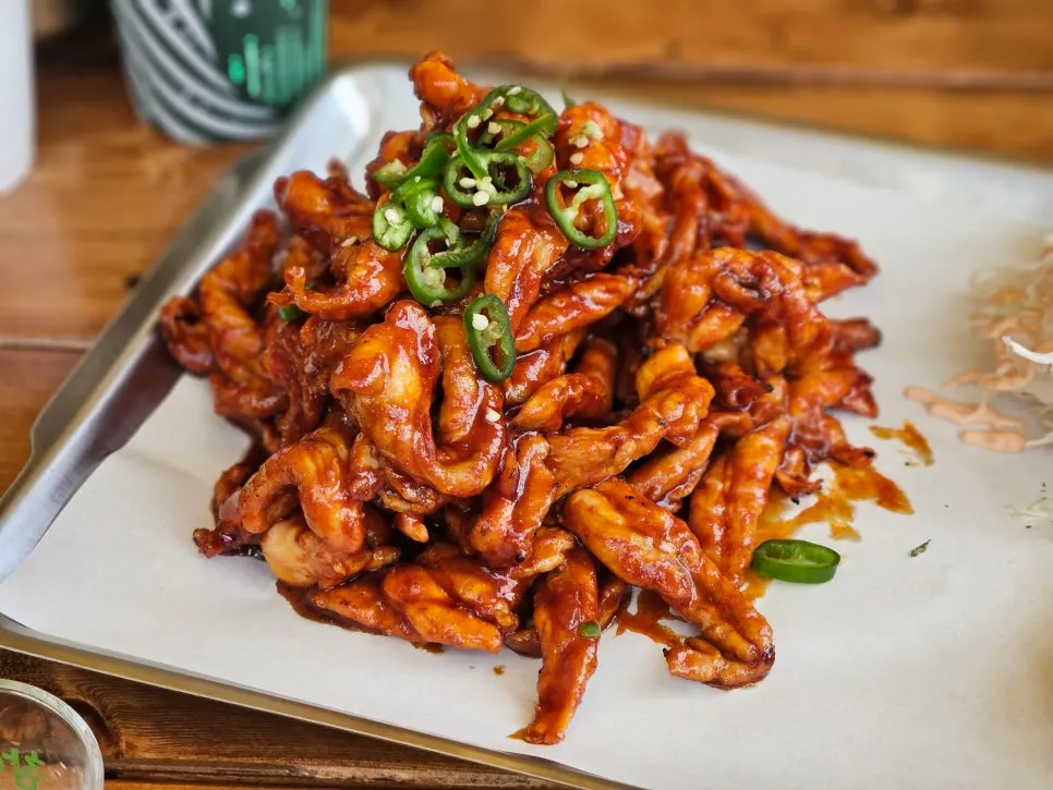 Close-up of glossy sauce-coated chicken neck