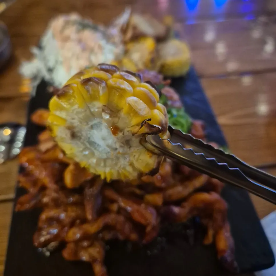 Close-up of grilled chicken neck topped with cheongyang chili