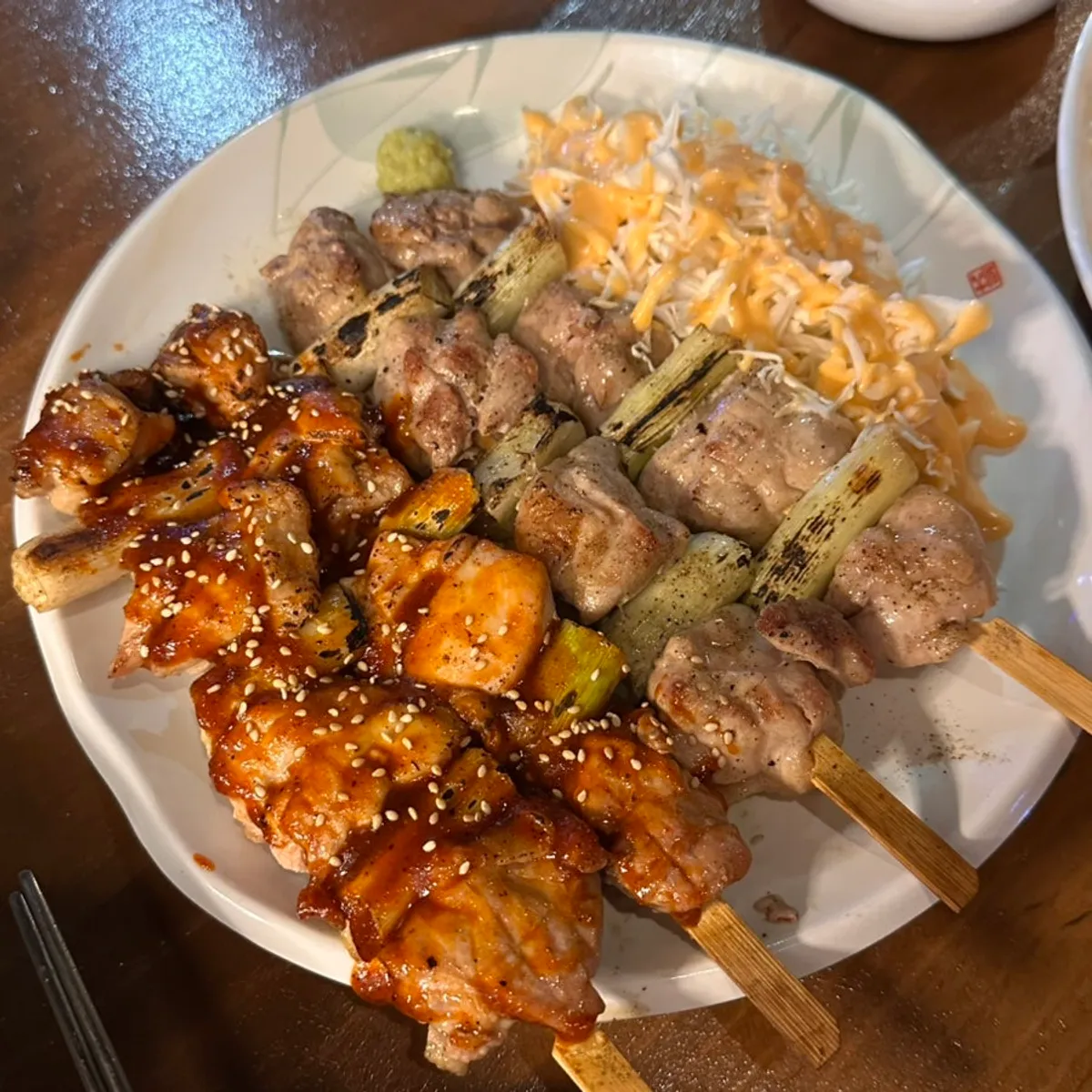 A plate of plump charcoal-grilled chicken skewers