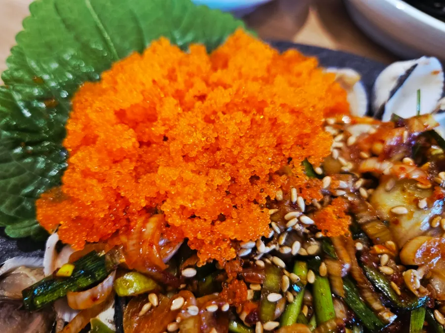 Seasoned cockles topped generously with flying fish roe