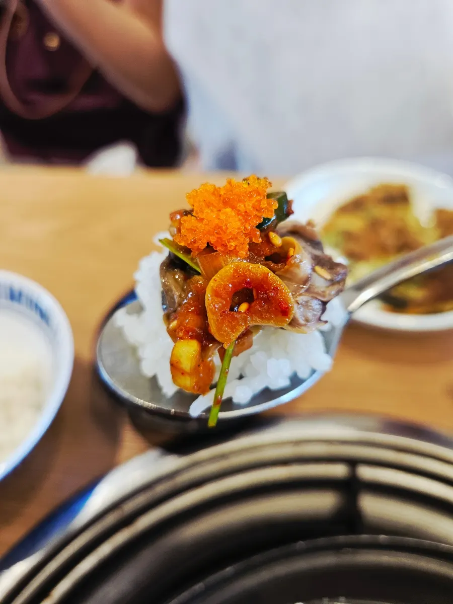 Seasoned cockles and flying fish roe over white rice