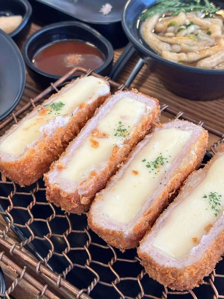 Cross-section of Kkot Gatsu tenderloin cutlet showing juices