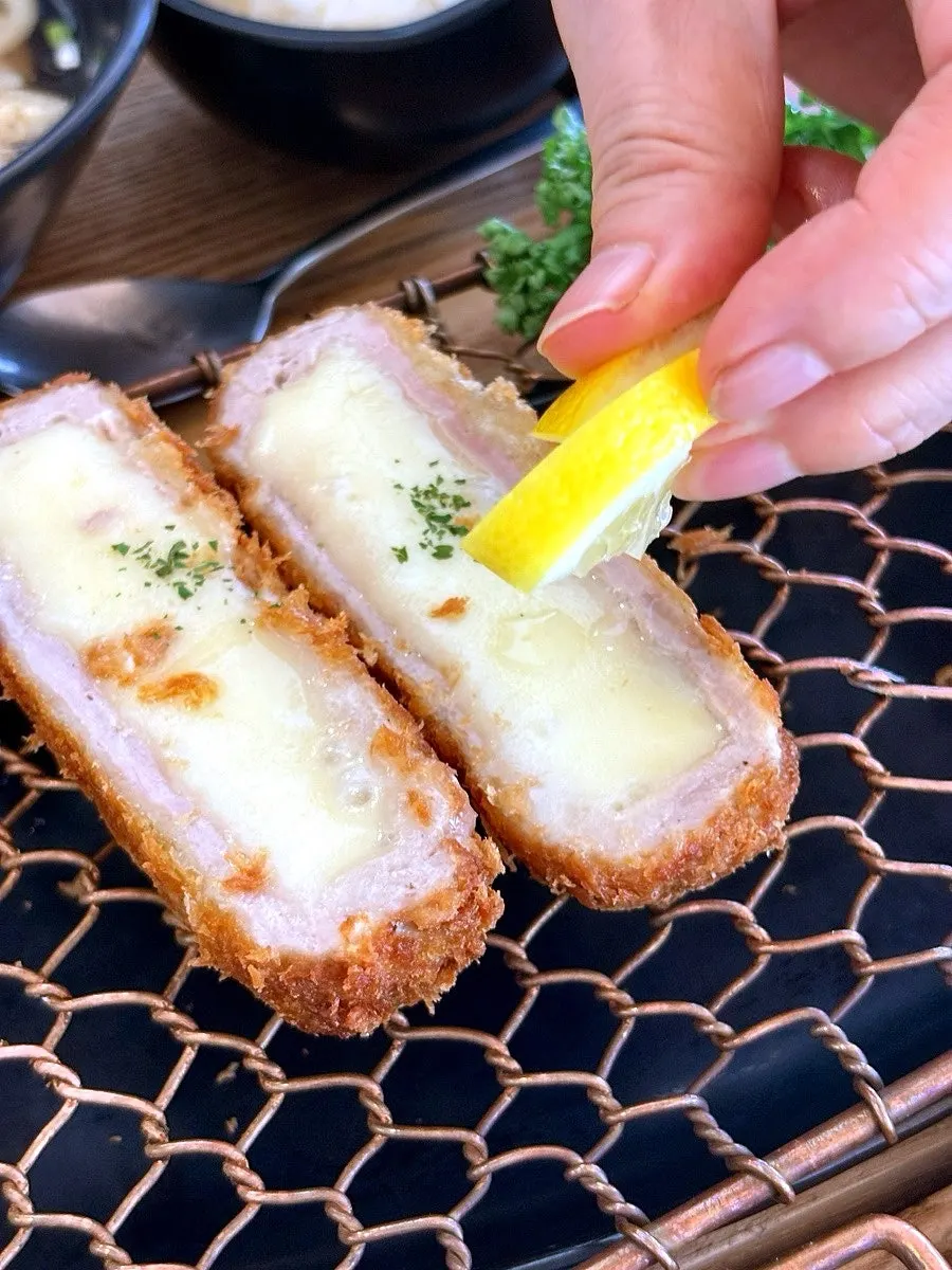 Melted cheese stretching from the cheese cutlet