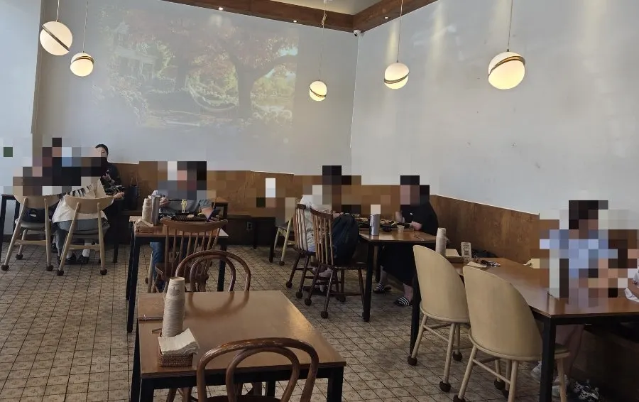 Kkot Gatsu dining hall seating under soft lighting