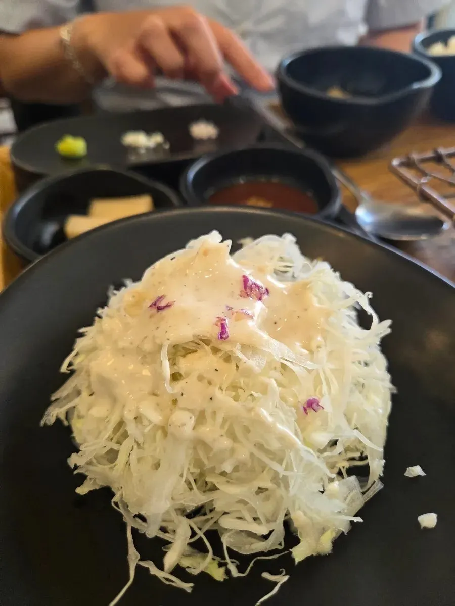 Lemon salt and sauce served alongside the cutlet
