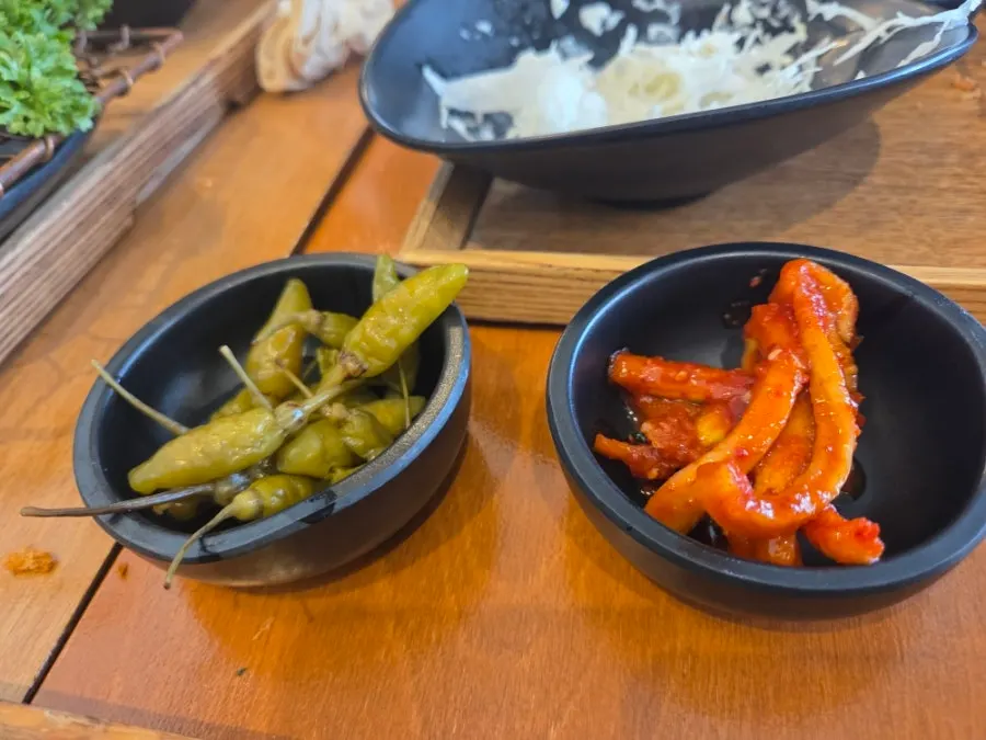 Plate of salad and pickles served on the side
