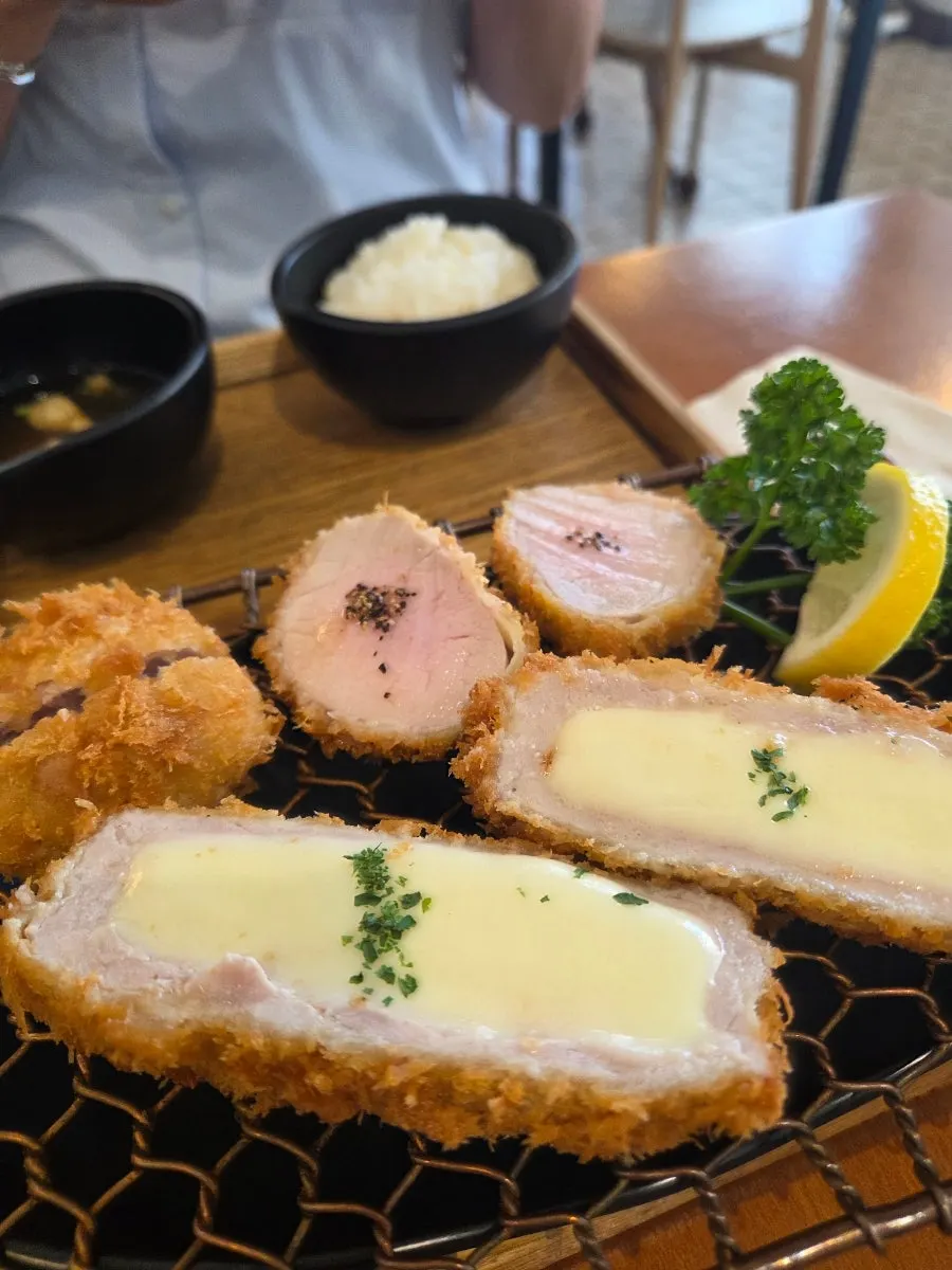 Picking up a piece of Kkot Gatsu pork cutlet