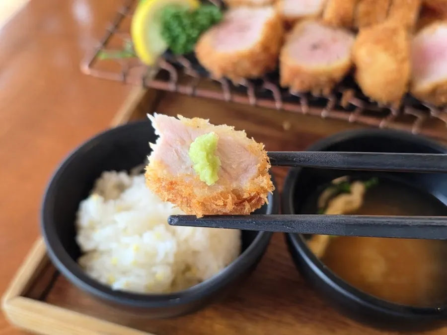 A piece of cutlet dipped in classic tonkatsu sauce