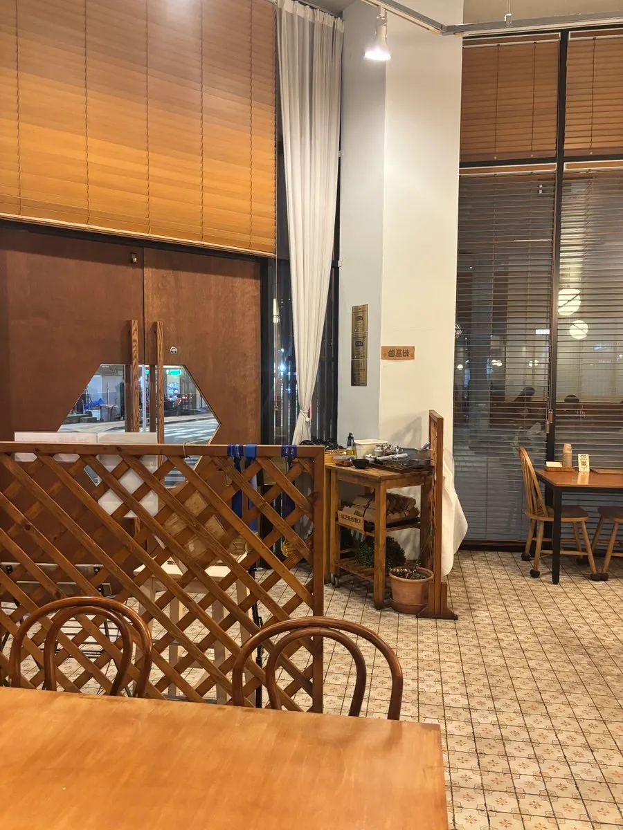 Interior of Kkot Gatsu with wood tones and yellow lighting