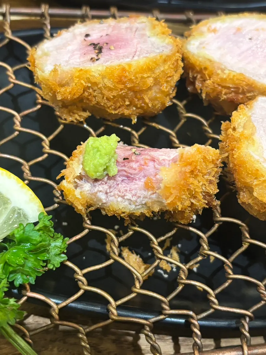 A piece of Kkot Gatsu topped with salt