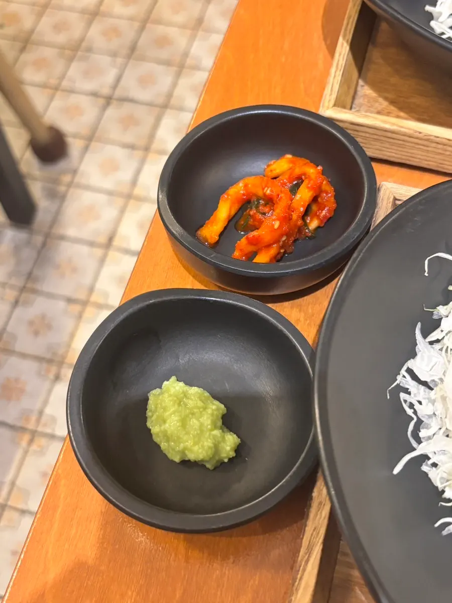 A plate of tonkatsu served with red radish strips