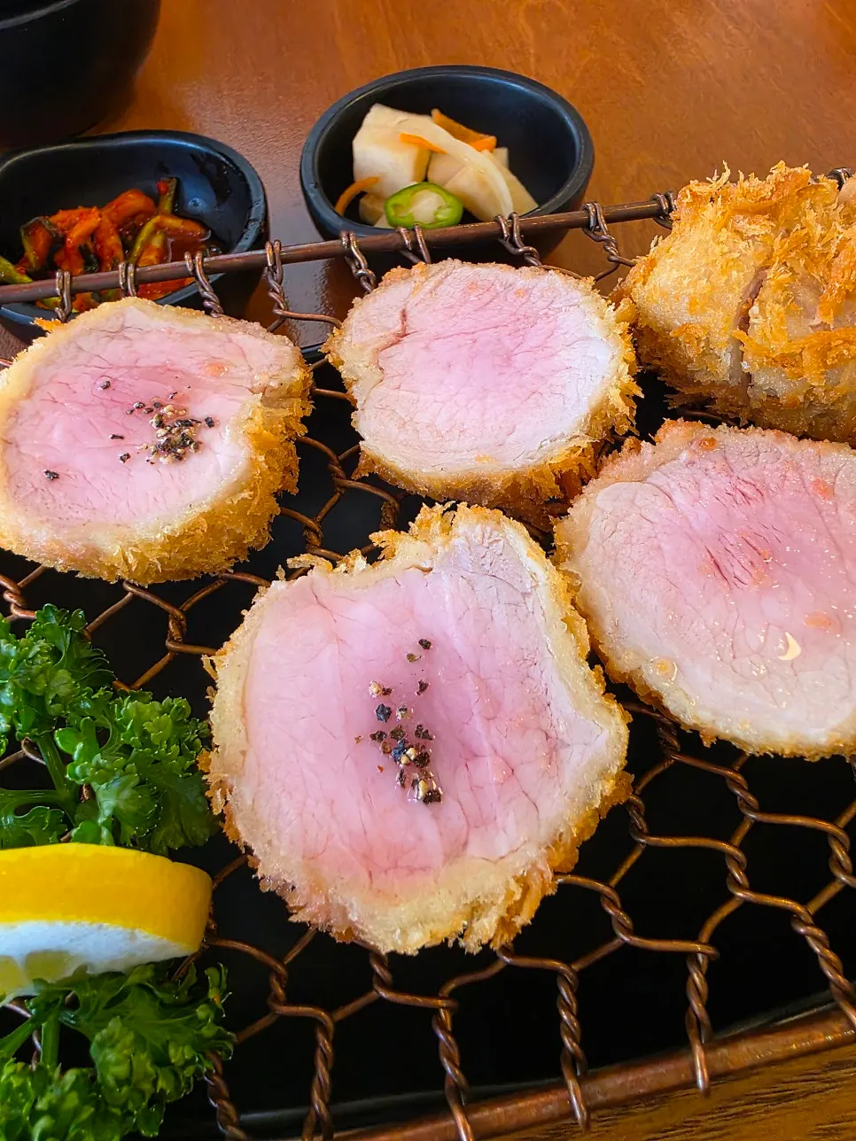 Chopsticks lifting a piece of soft tenderloin cutlet