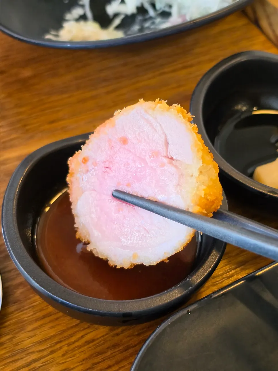 A piece of kkot gatsu topped with lemon juice