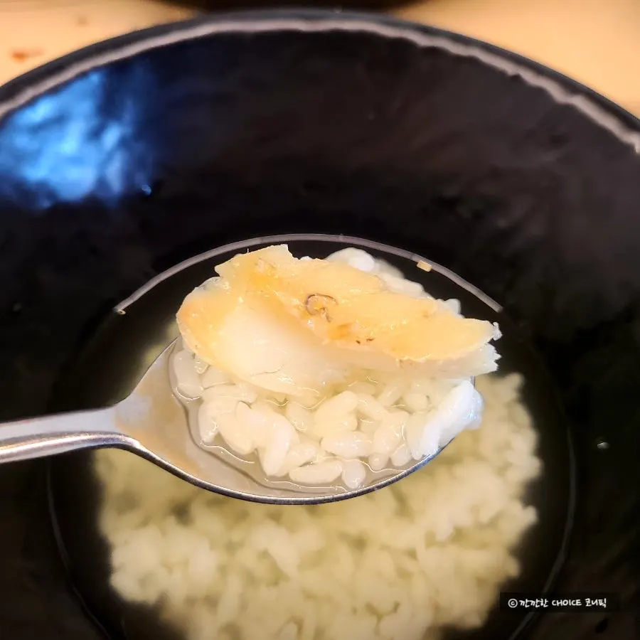 A spoonful of rice with dried corvina