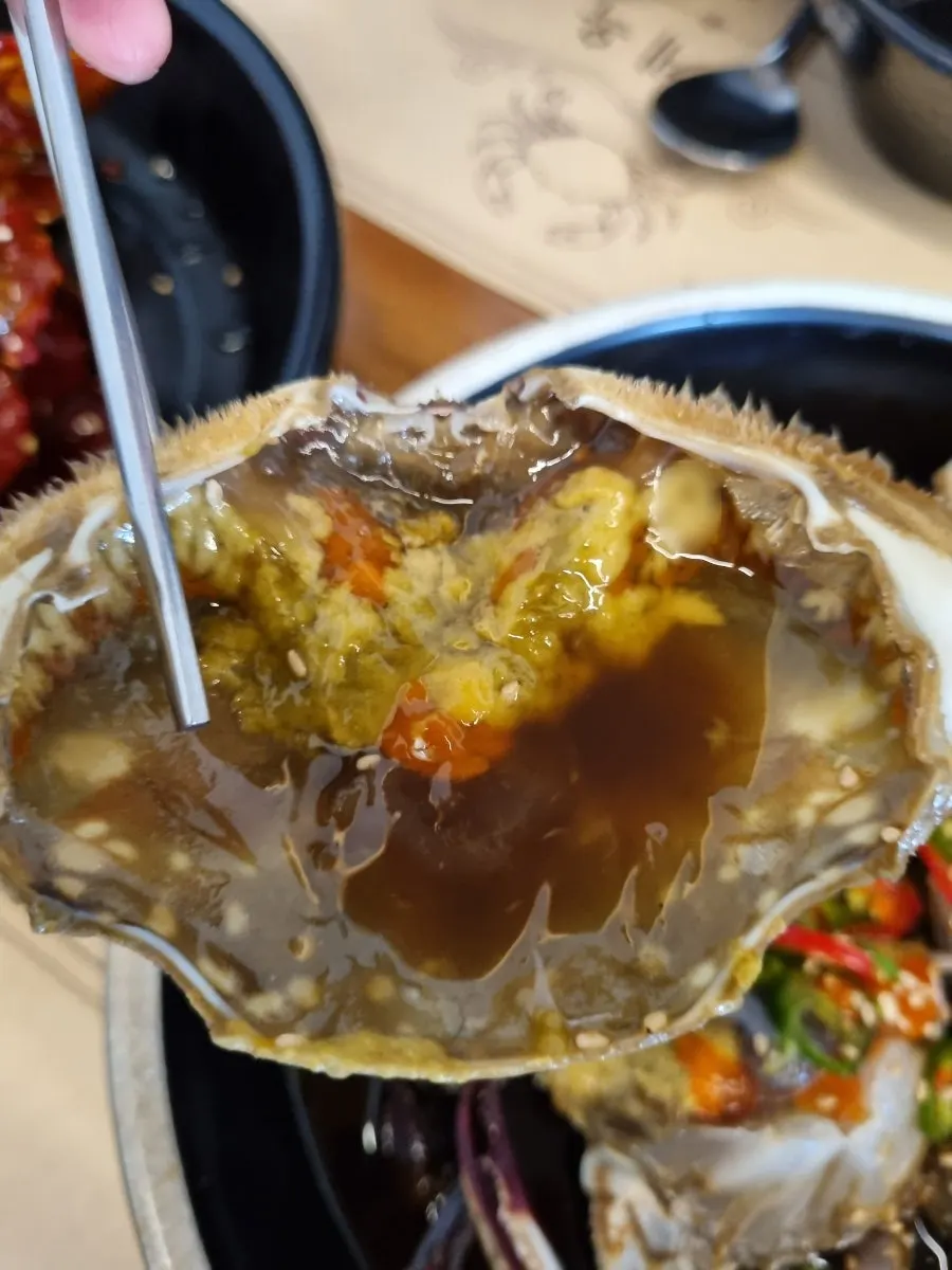 A spoonful of rice topped with crab meat