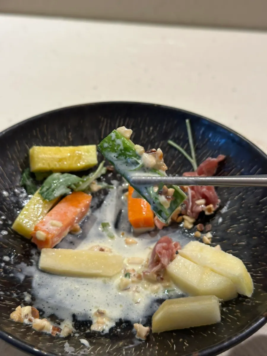 Grilled vegetable salad plate served by staff