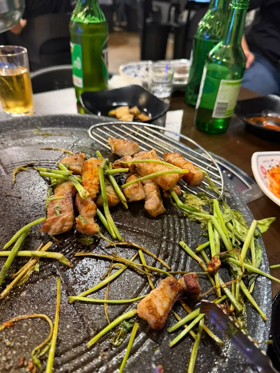 Grilled pork belly topped with minari