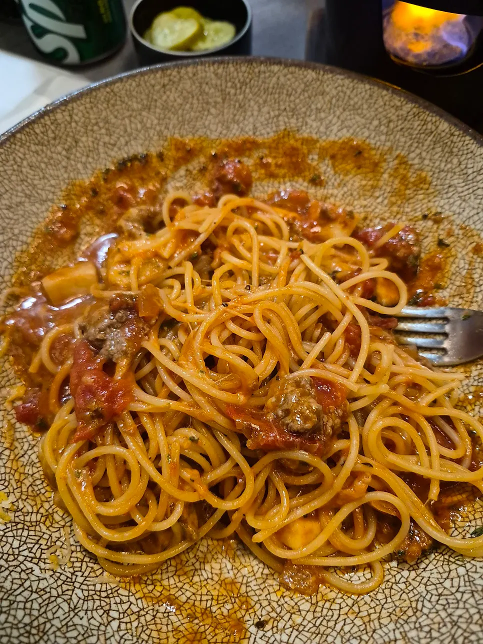 Cheese meat pasta topped with cheese like snow