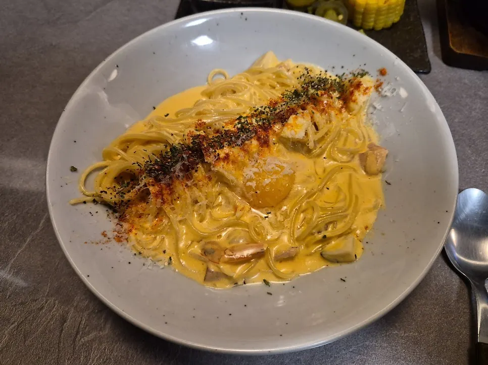 A forkful of cheese meat pasta lifted up