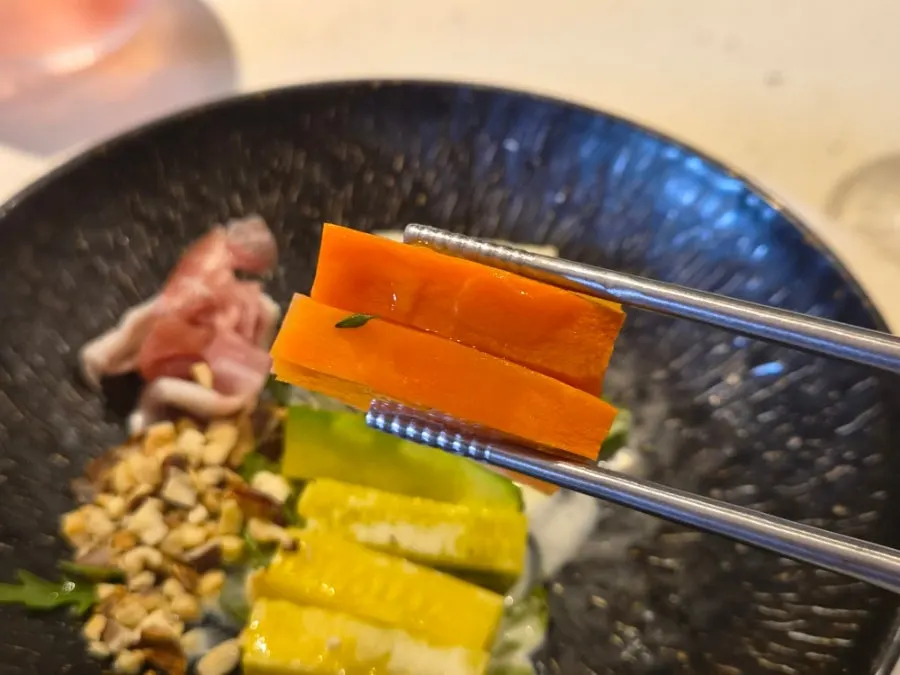 Grilled vegetable salad plate served with prosciutto