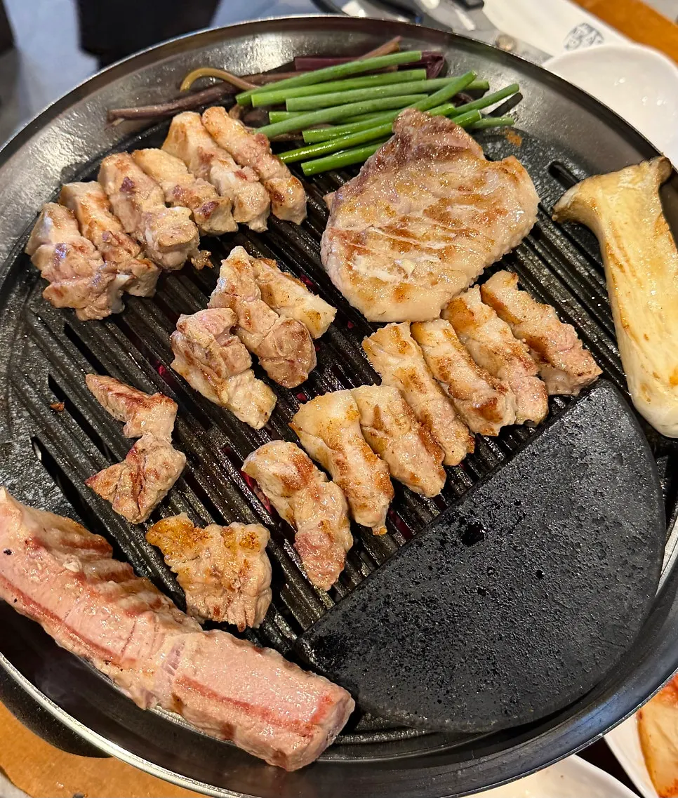 Staff member grilling meat and vegetables