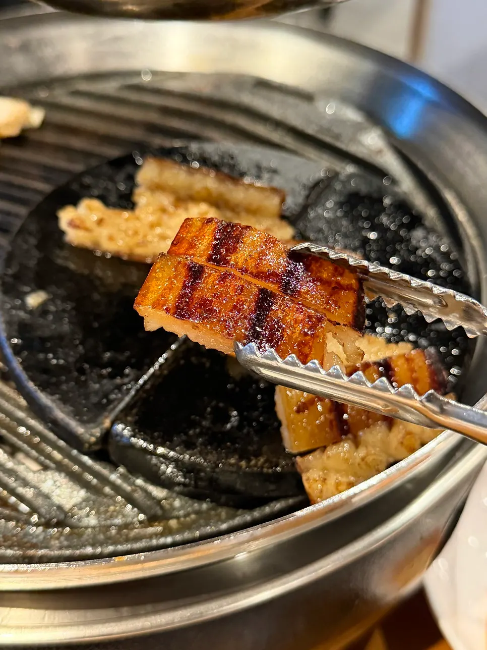 Grilled pork skin served at the end of the meal