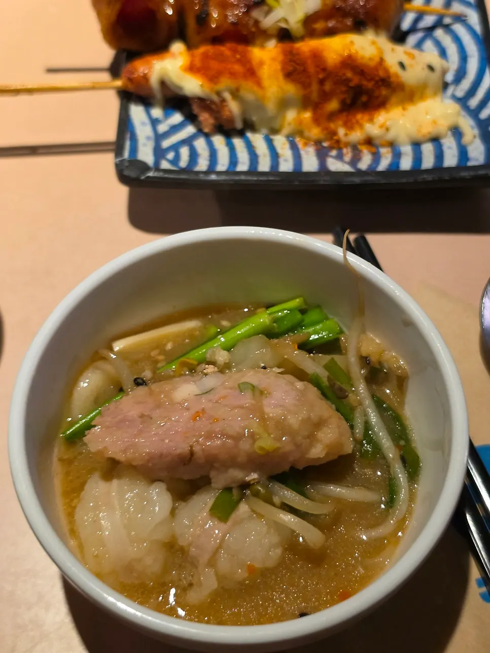 Motsunabe broth and meatballs served in a small bowl