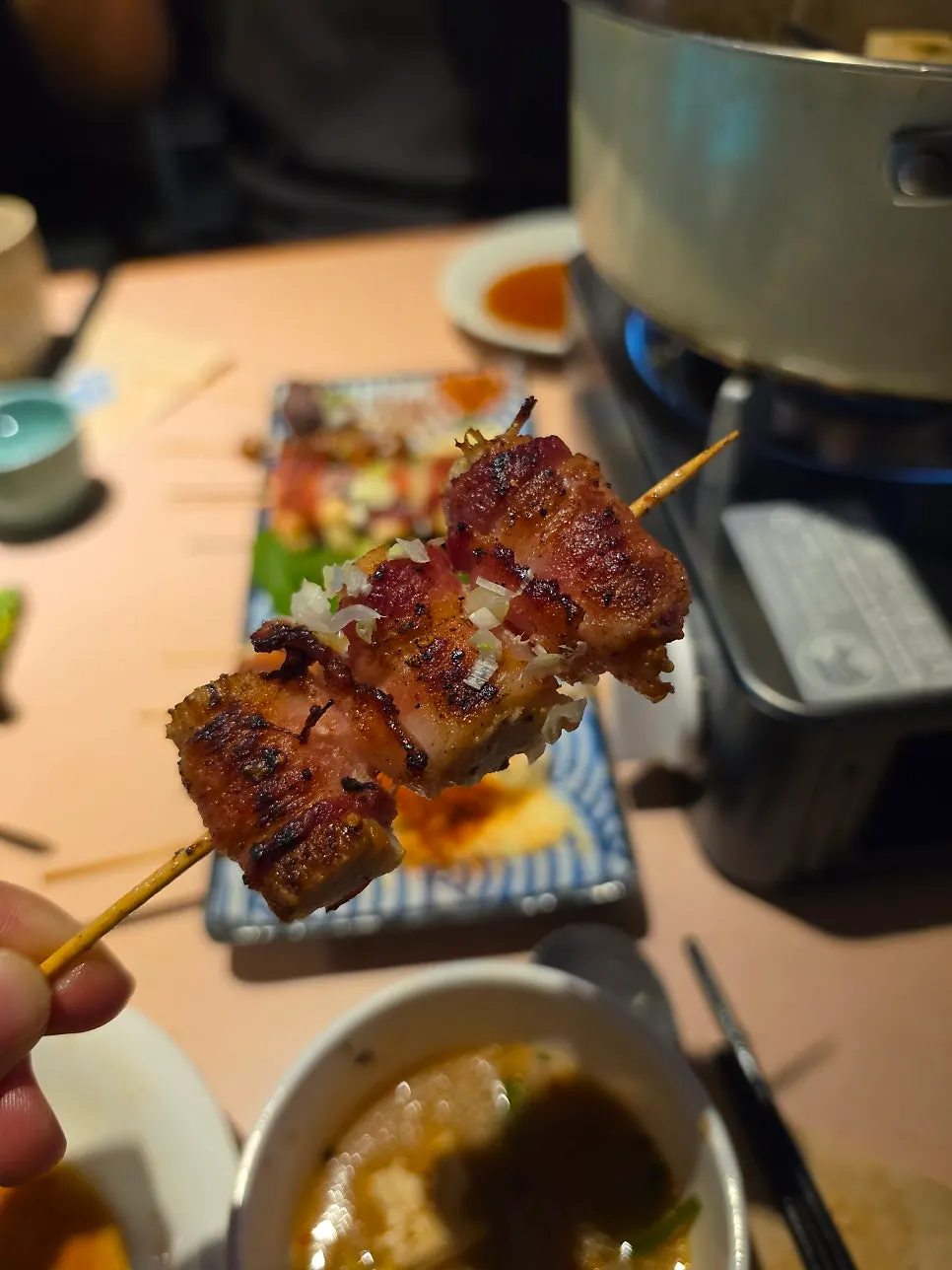 Half-eaten yakitori skewers with a drink glass