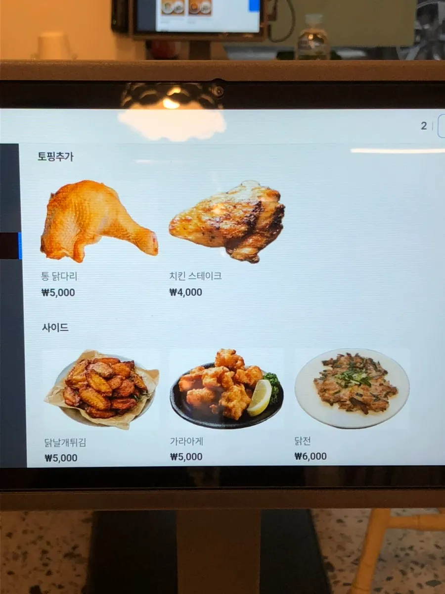 Extra toppings and side menu board at Cocker Noodle Two