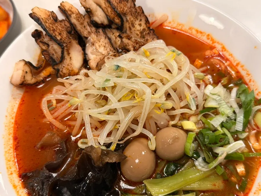 Spicy char siu ramen topped with bean sprouts and wood ear mushrooms