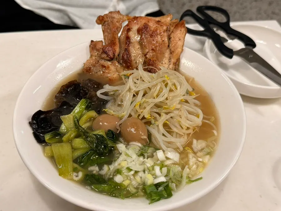 Close-up of ramen topped with quail eggs and meat