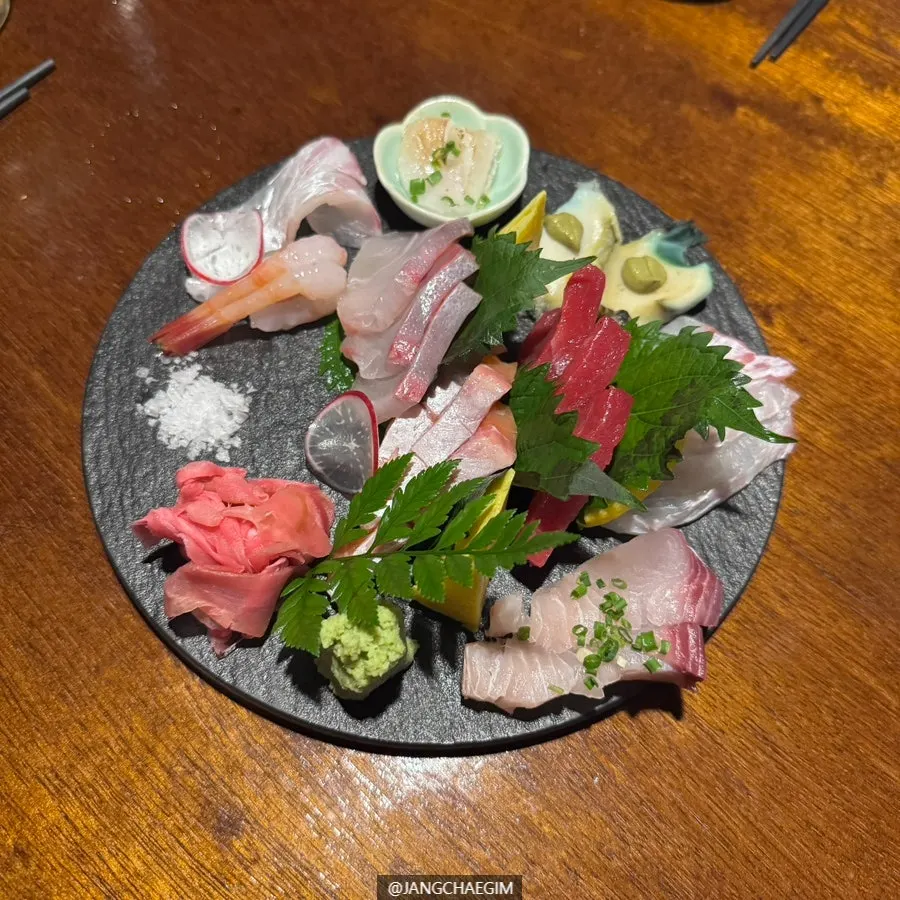 Close-up of aged sashimi including flounder, amberjack, and tuna