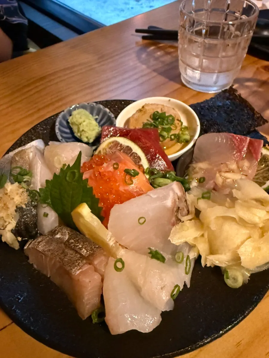 A variety of sashimi including mackerel, flounder, and sea bream