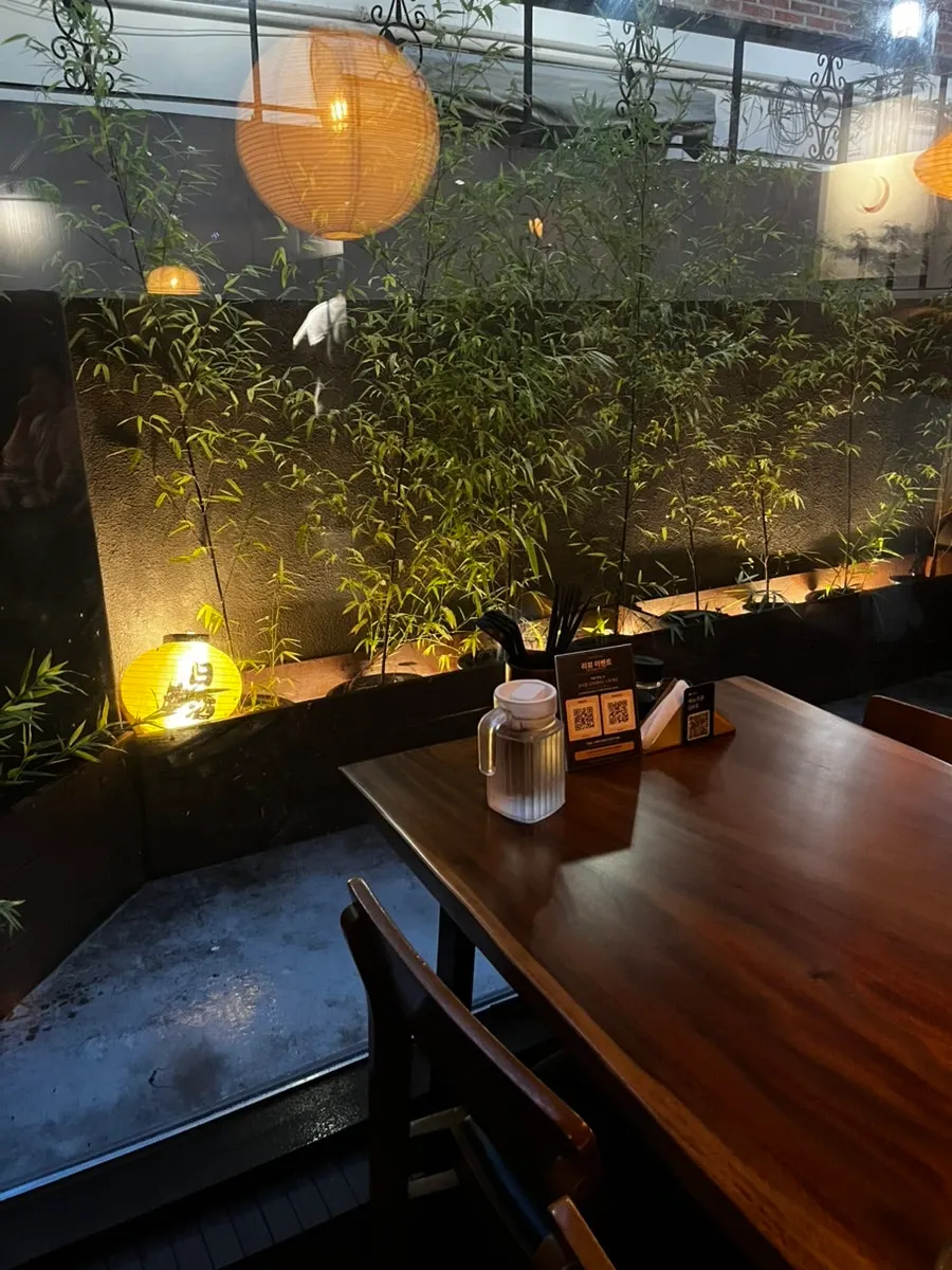 Table seating with ambient lighting at Koma Yeonnam