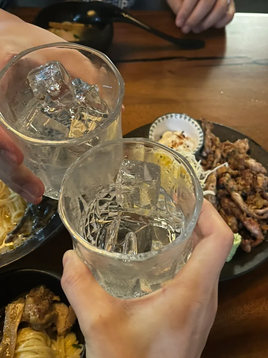 A glass of drink diluted with ice