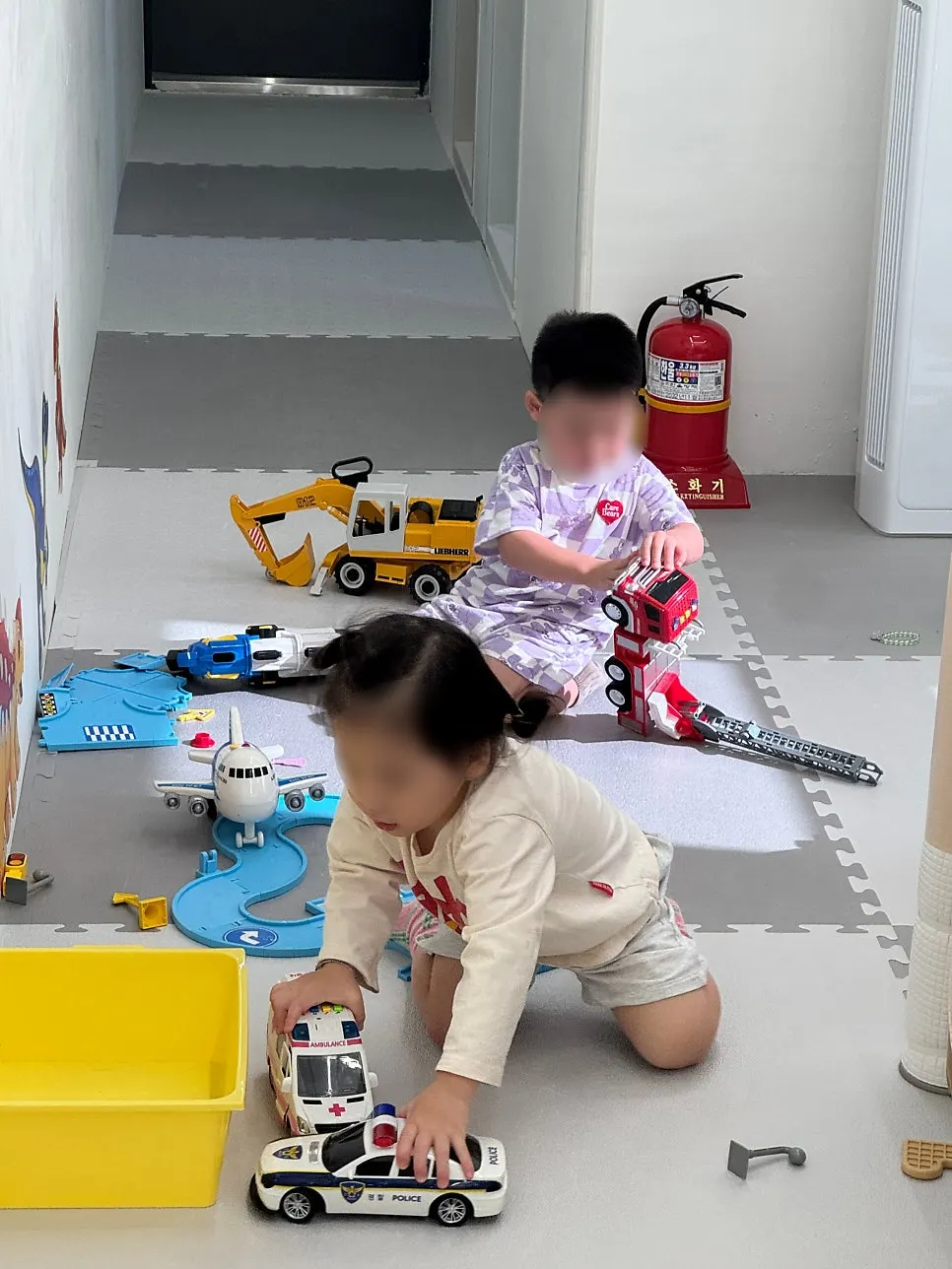 A child rolling a toy car around