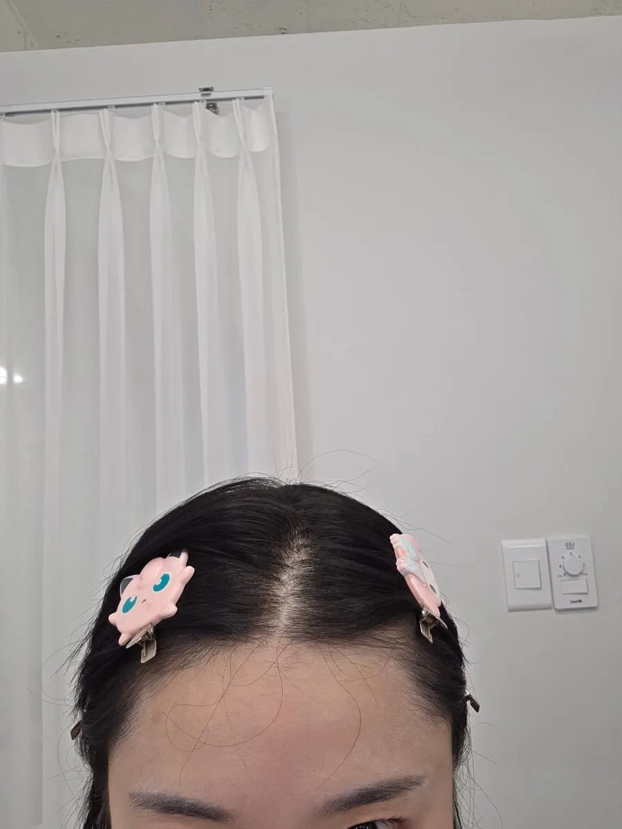 Start of makeup with hair parted and pinned back