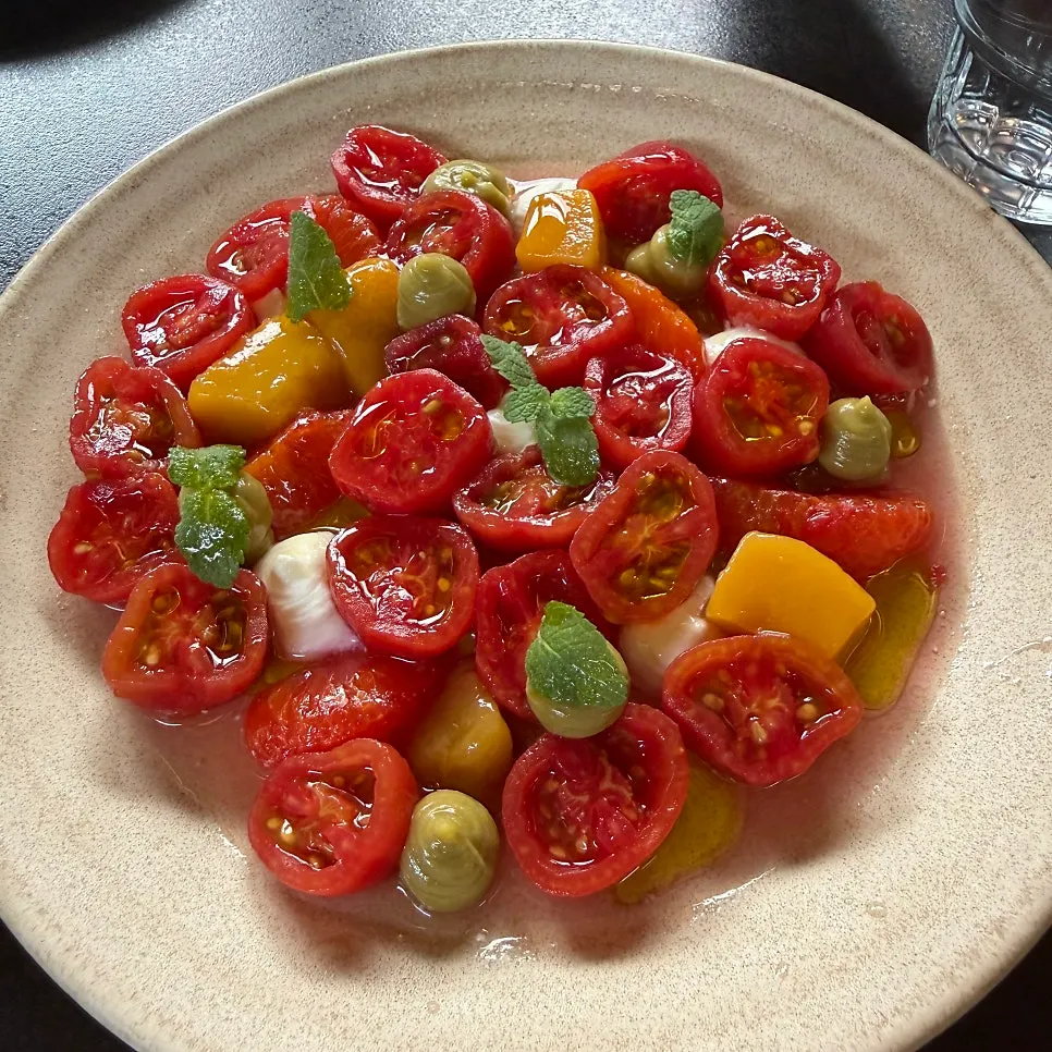 Tomato salad topped with avocado puree and yuzu sauce