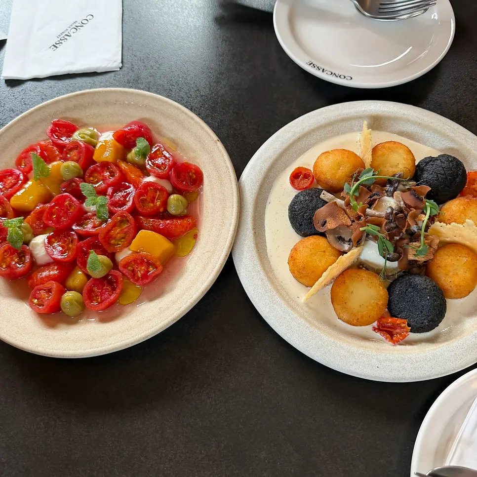 Close-up of peeled cherry tomatoes and mango in the salad