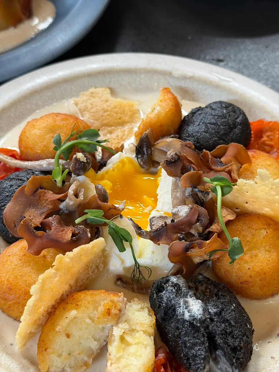 Potato gnocchi plated with a poached egg on top