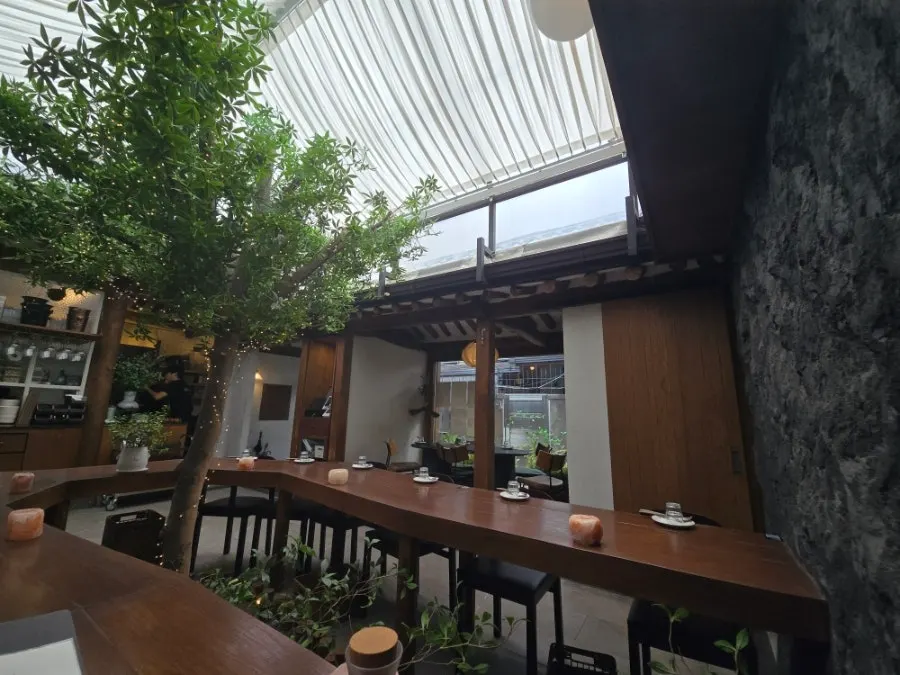 Concasse Anguk dining hall showing exposed wooden structure