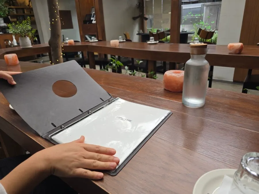 Wooden table seating under soft lighting