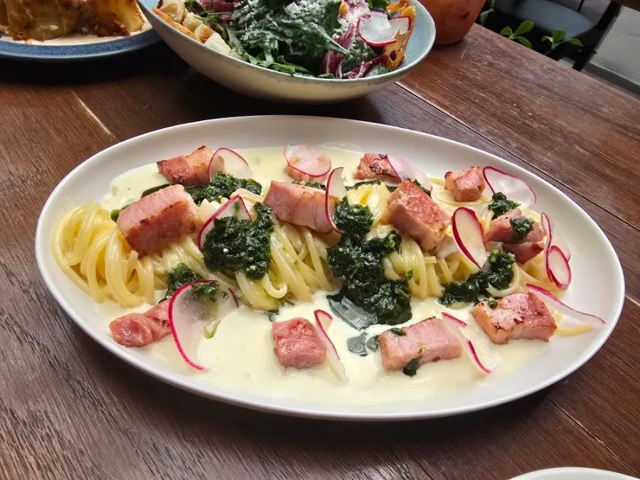 Table with lasagna and wasabi cream pasta together