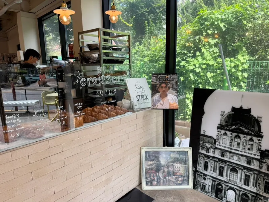 Café entrance with a mirror and croissant decoration