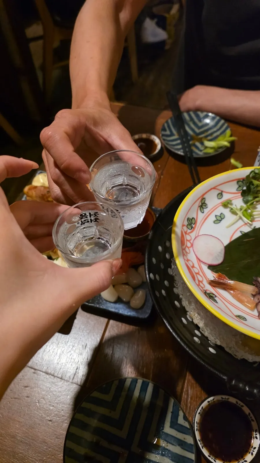 A full spread of assorted sashimi and charcoal skewers