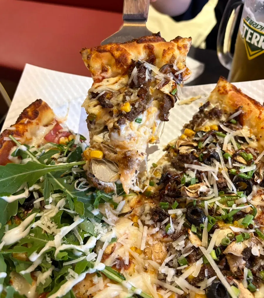 Close-up of Philly cheese barbecue steak pizza toppings